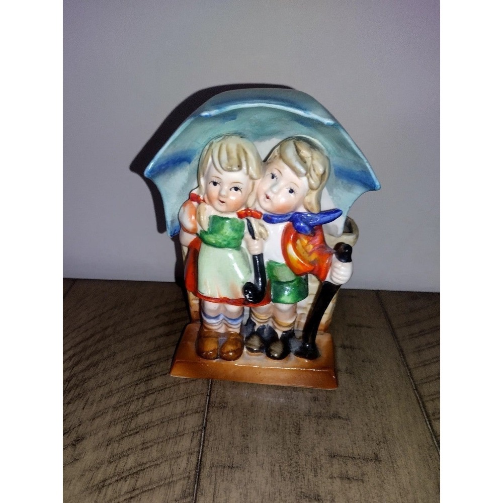 Vintage Hummel boy and girl under an umbrella ceramic planter